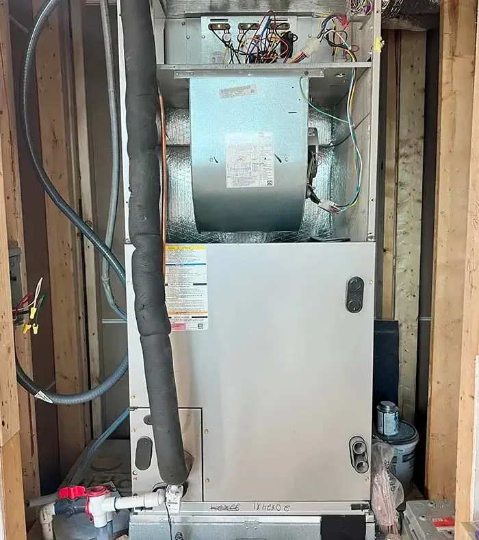 Air handler unit being installed in a framed utility closet during new construction -- Cold Factor HVAC installation Flower Mound TX