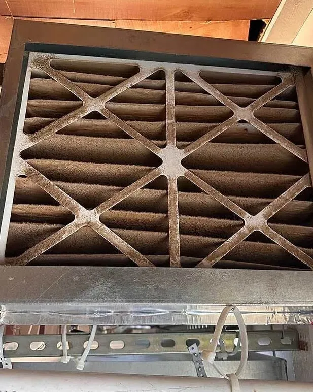 Heavily clogged air duct filter with dust and debris buildup -- Cold Factor air duct cleaning Flower Mound TX