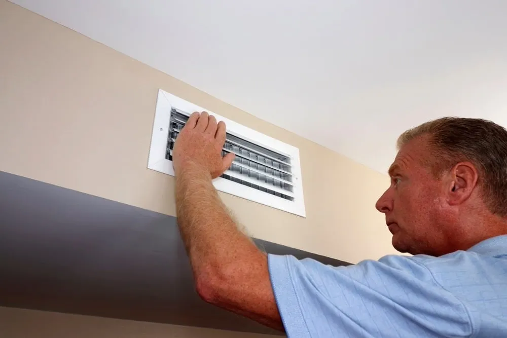hand hovering over AC vents