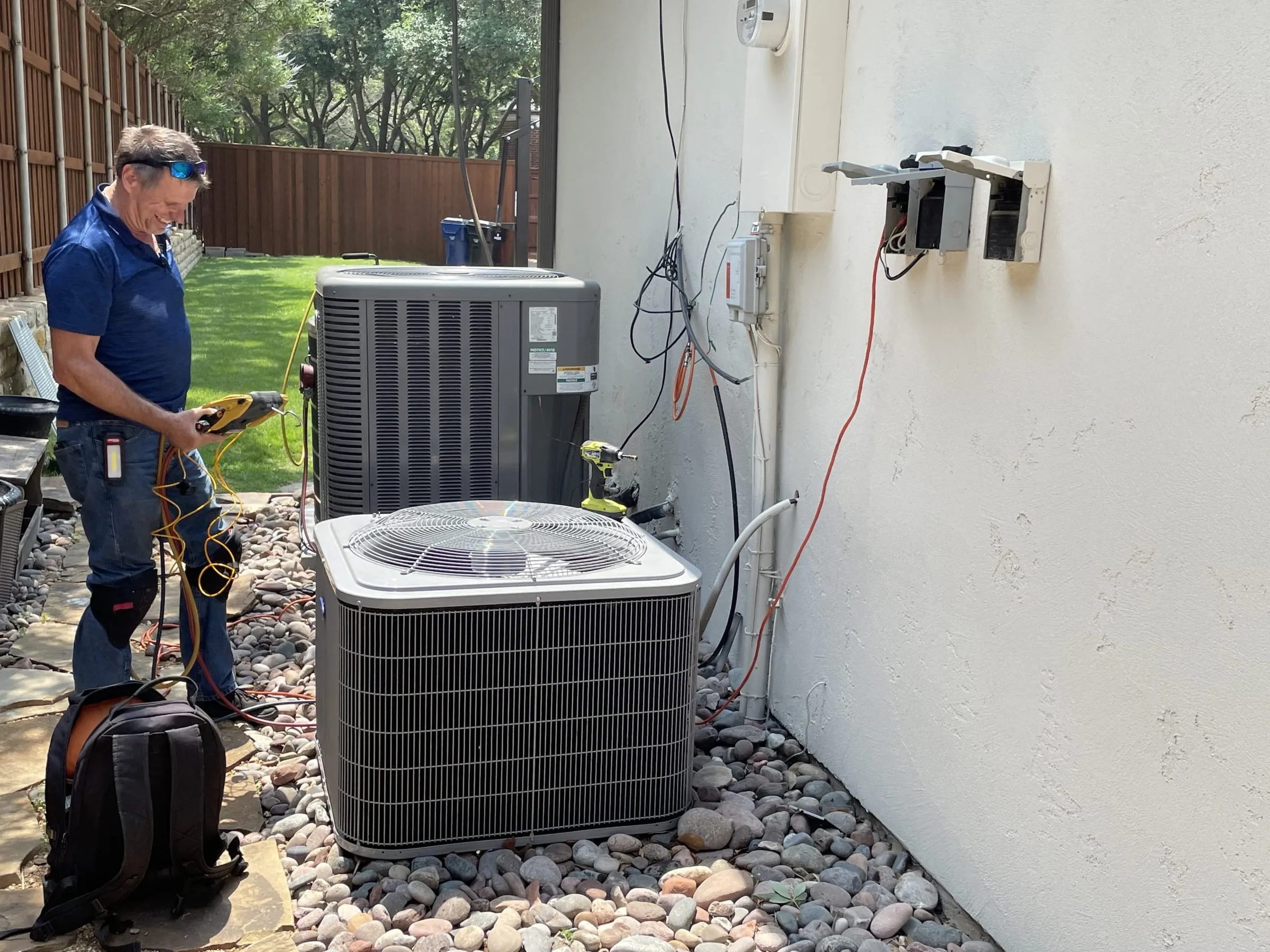 hvac technician working on ac units