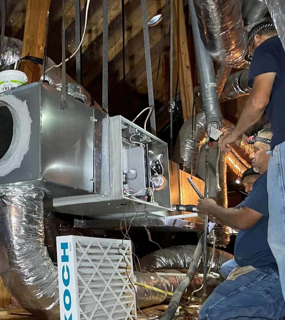 Cold Factor technicians installing an HVAC air handler unit and ductwork in a residential attic in Flower Mound TX