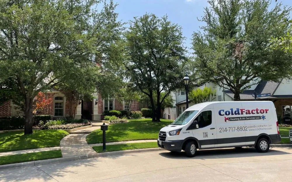 Cold Factor service van parked on a tree-lined residential street