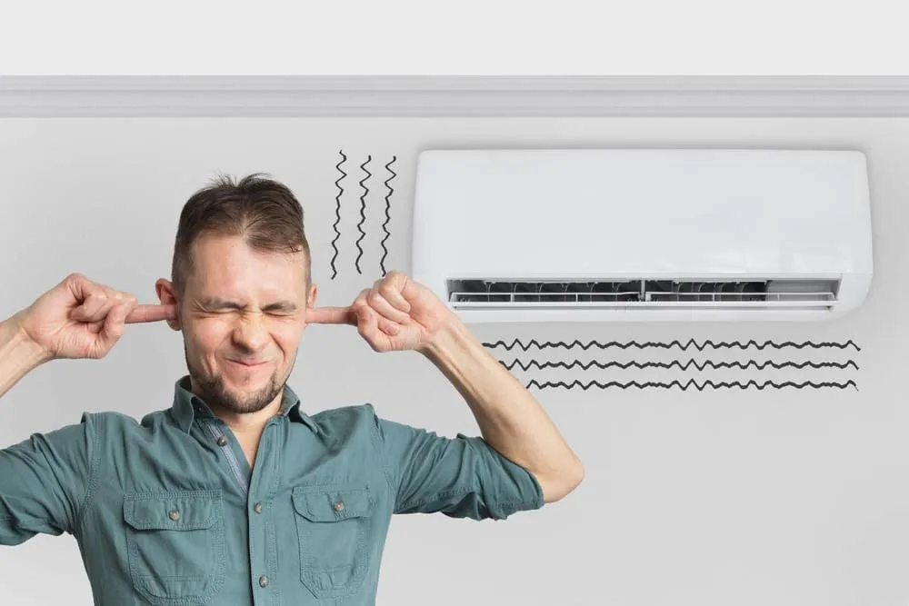 person pressing their ear onto an AC unit