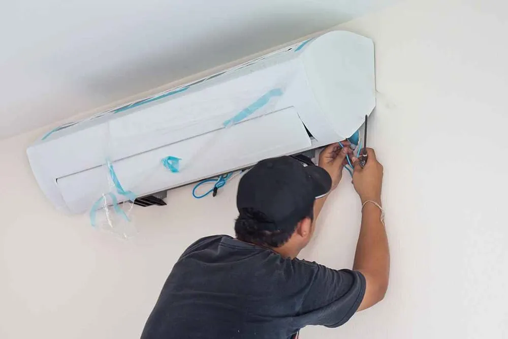 technician installing a new AC unit