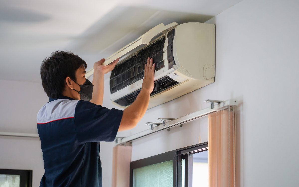 AC tech installing indoor unit