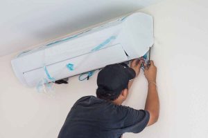 technician installing a new AC unit
