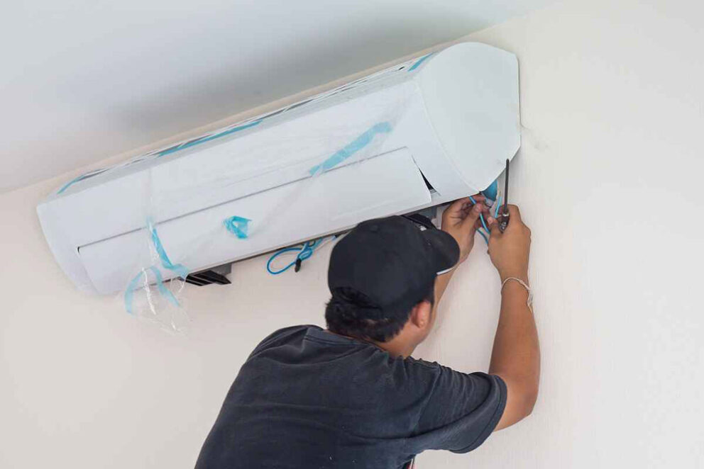 technician installing a new AC unit