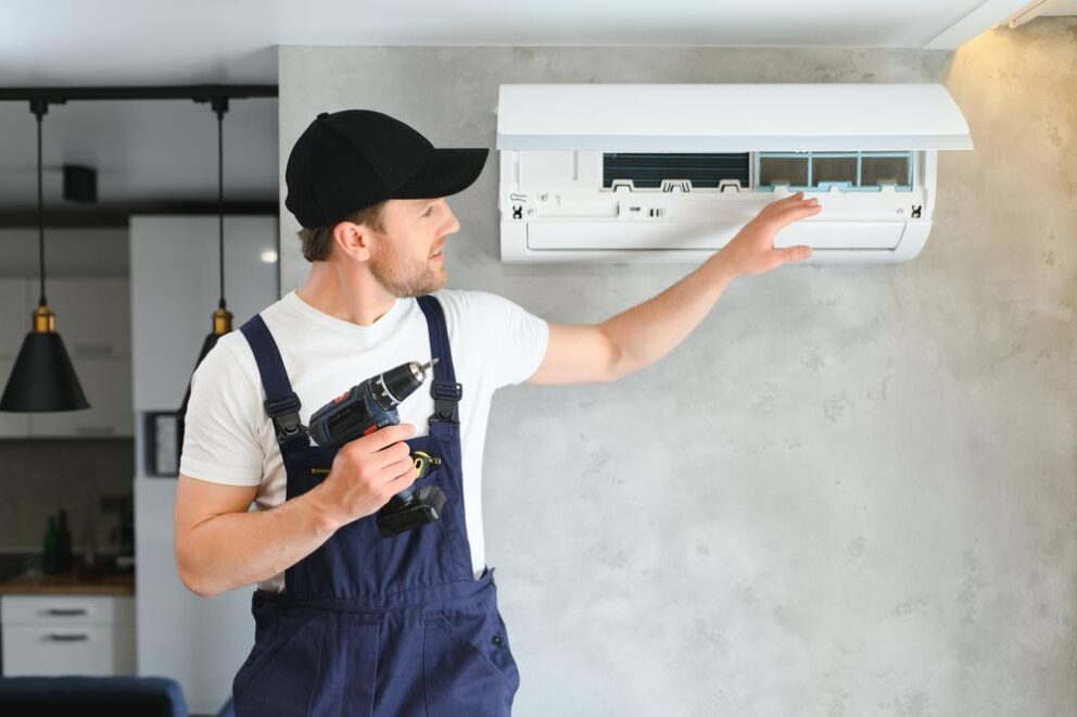 technician tinkering with an AC