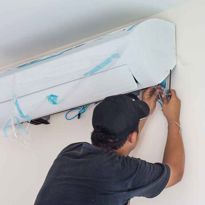 technician installing a new AC unit